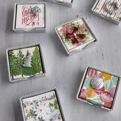 six small square trays with christmas designs on them, all decorated in different styles and colors