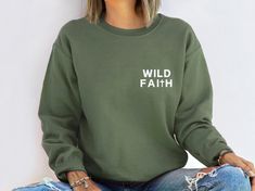 This embroidered Wild Faith sweatshirt is super soft and cozy. Perfect to lounge around, run errands, or walk your dog. Our crewnecks use the highest quality material for ultra-soft and comfortable wear, with advanced embroidery to ensure vibrant colors and detailed graphics. Product Details: ✨ * 50% cotton, 50% polyester * Pre-shrunk * Classic fit * 1x1 athletic rib knit collar with spandex * Air-jet spun yarn with a soft feel and reduced pilling * Double-needle stitched collar, shoulders, armholes, cuffs, and hem Sizing👚 All sweatshirts come in multiple colors and 6 different sizes, ranging from Small to XXX-Large. This unisex crewneck sweatshirt is intended to be loose/oversized for women to give a chic and laid-back vibe. If you want something more fitted, we recommend ordering a size Green Casual Sweatshirt With Embroidered Text, Casual Green Sweatshirt With Embroidered Text, Faith Sweatshirt, Advanced Embroidery, Christian Apparel, Spiritual Gifts, Religious Gifts, Christian Clothing, Embroidered Shirt