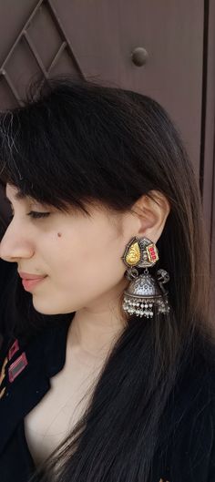 Naaz Megha is a part of our artistic silver lookalike jhumkas. They are handcrafted in Silver alloy, Brass, and Silver Plating. Weight: 15 gms This elegant earring is an ideal gift for yourself, your partner, family, friends, and co-workers. These beautiful jhumkas are perfect as gifts for Christmas, Thanksgiving, New Year, Birthday, Engagement, Wedding, Anniversary and Mother's Day. USP: Lightweight design ensures comfort for all-day wear. *Handmade and handcrafted products come with minor irre Silver Latkans Earrings For Puja, Silver Earrings For Diwali Puja, Fusion Style Danglers With Latkans For Navratri, Silver Earrings For Puja And Diwali, Silver Fusion Chandbalis With Latkans, Silver Chandbali Earrings For Puja, Silver Fusion Style Chandbalis With Latkans, Fusion Style Silver Chandbalis With Latkans, Silver Dual-tone Earrings For Navratri