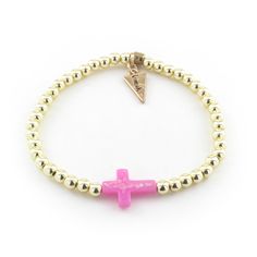 Beautifully dainty, the cross bracelet brings all the charm. The classic design made with gold plated beads and a sparkly pink cross is perfect for everyday wear and will no doubt become a timeless piece in your collection. Bracelets are 'one size fits most' and are designed to fit wrists up to 7.5" comfortably. Synthetic Stretch Lead & Nickel Free Please be aware that due to the unique and handmade nature of each product, colors, shapes, and bead sizes may vary slightly from the photos and desc Gold Cross Beaded Bracelets For Gift, Adjustable Gold Beaded Cross Bracelets, Gold Cross-shaped Beaded Bracelets For Gifts, Gold Beaded Cross Bracelets For Spiritual Style, Gold Cross Beaded Bracelets For Spiritual Style, Gold Cross-shaped Spiritual Beaded Bracelets, Gold Spiritual Beaded Cross Bracelets, Spiritual Gold Beaded Cross Bracelets, Adjustable Pink Cross-shaped Jewelry