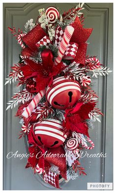 a christmas wreath with candy canes and ornaments hanging on the side of a door