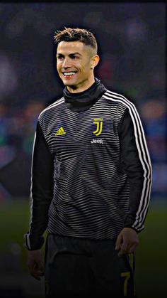 the soccer player smiles as he walks on the field