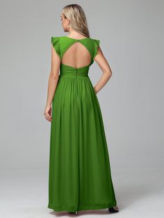 a woman in a long green dress with open back