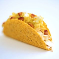 a tortilla filled with meat and cheese on top of a white countertop