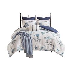 a bed with blue and white flowers on it