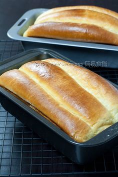 two loafs of bread sitting on top of a pan