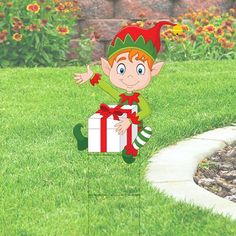 a cartoon elf holding a gift box in the grass with flowers behind it on a lawn