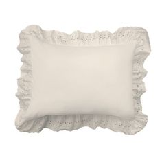 a white pillow with scalloped edges on a white background, it looks like something out of the victorian era