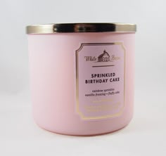 a pink candle that is sitting on a table