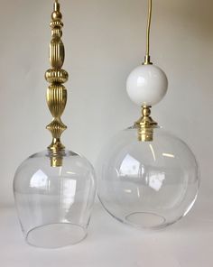 two clear glass lamps sitting next to each other