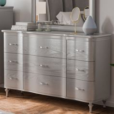 a silver dresser with a mirror on top of it