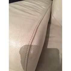 the back end of a white leather couch