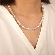 Refined and timeless, this classic pearl necklace showcases a single strand of cultured freshwater pearls, each elegantly rounded and perfectly matched. This seamless arrangement exudes a pure and charming femininity, ideal for any occasion, from casual outings to formal events. Its simple yet sophisticated design enhances natural beauty with a touch of understated luxury. *Each piece is handmade, resulting in a potential variance of 0.1-0.2mm during measurement. Please refer to the actual item for precise specifications.  *Cultured pearls are naturally formed, and their color and size may differ slightly. Stone Size: 7.5-8 mmStone Type: PearlNumber of Stones: 43 Stone Color: Pearl WhiteStone Shape: RoundWidth: 7.5-8 mmThickness: 7.5-8 mmMaterial: 10K/14K/18K Solid Gold , PlatinumGrade: AA Refined Pearl Necklace With Pearl Chain, Timeless Pearl Necklace With Pearl Pendant, Refined Pearl Chain Necklace, Refined Pearl Necklace, Elegant Necklace With Pearl Charm And Round Beads, Elegant Pearl Necklace With Pearl Drop, Adjustable Round Pearl Necklace, Elegant Necklaces With Pearl Charm And Round Beads, Refined Pearl White Necklace With Pearl Chain