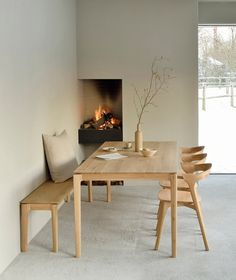 a dining room table with chairs and a fire place