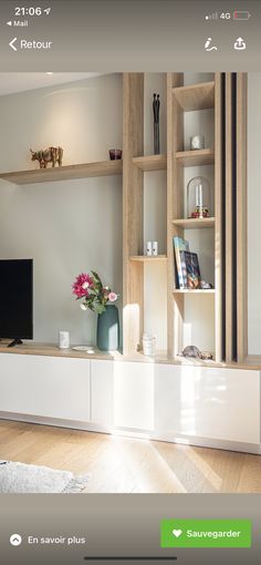 a living room filled with furniture and a flat screen tv on top of a wooden shelf