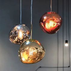 three different colored lights hanging from the ceiling