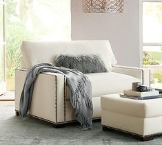 a white couch and ottoman in a room