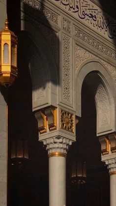 two white pillars with gold and black decorations on them