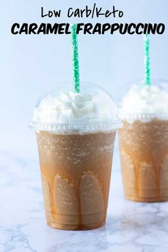 two drinks with whipped cream on top and green straws in the middle, sitting next to each other