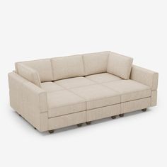 a beige couch sitting on top of a white floor