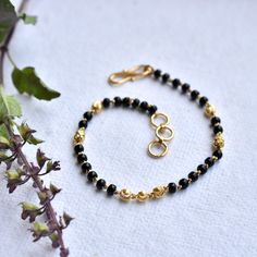 "Single strand gold chain bracelet with black beads and gold balls, handcrafted with love and care, this comfortable bracelet is a perfect accessory for everyday wear. Lightweight and stylish..! * Length : 5.5\" to 9\" + 0.5\" extender eg : 6\" length will fit wrist size of 6\"- 6.5\" * Gold : 18k Solid Yellow Gold * Gold Weight - 2.5 gms approx for 5.5\" inches with extender - For longer/shorter length, please ask for a quote before placing the order. If you like this bracelet, please press \"P Karimani Bracelet For Ladies, Black Beads Bracelet Gold For Women, Black Beads Bracelet Gold, Shashi Bracelet, Bracelet With Black Beads, Gold Bracelet Indian, Black Gold Bracelet, Baby Bracelet Gold, Black And Gold Bracelet