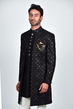 Black open sherwani with mandarin collar, all over geometric checkered pattern, tonal thread and sequin embroidery. Paired with kurta with embroidered collar and white straight pant.
Components: 3
Pattern: Embroidered
Type Of Work: Thread and Sequin Work
Neckline: Mandarin Collar
Sleeve Type: Full Sleeves
Fabric: Crepe, Handloom Silk, Terry Rayon
Color: Black
Other Details: 
Embellished buttons
Front and side slits
Kurta Closure: Front concealed placket
Note: The brooch and pocket square worn by Open Sherwani, Embellished Buttons, Tarun Tahiliani, Sequin Embroidery, Embroidered Collars, Sequins Embroidery, Sherwani, Black Boys, Full Sleeves