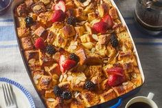 a casserole with fruit on top and coffee in the middle, sitting on a table