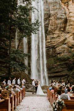 an image of a couple getting married in front of a waterfall