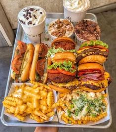 a tray filled with lots of different types of food next to cups of ice cream