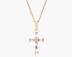 14K Rose Gold Moderne Cross Diamond Necklace. This classic cross necklace is a beautiful display of faith. Set in stunning 14K gold, tapered baguette-cut diamonds line the design with a brilliant round diamond at the center. The pendant hangs from an 18-inch cable chain with an extra jump ring at 16 inches for versatility and secures with a lobster clasp. Elegant Rose Gold Diamond Cross Necklace, Elegant Formal Crucifix Diamond Necklace, Elegant Cross Shaped Jewelry With Baguette Diamonds, Elegant Cross Jewelry With Baguette Diamonds, Diamond Necklaces, Baguette Cut Diamond, Cross Jewelry, Baguette Cut, Jump Rings