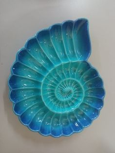 a blue glass dish sitting on top of a table