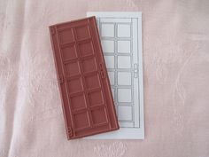 two chocolate bars sitting on top of a sheet of paper