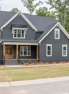 a gray house with white trim and windows