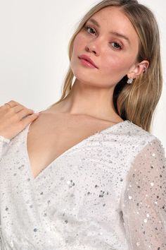 Make any memorable night even more spectacular with the Lulus Noticeable Shine White Sequin Beaded Long Sleeve Mini Dress! This dress features an array of shiny sequins (in varying shapes and sizes) and delicate beaded details that decorate a mesh overlay, that shapes a lightly gathered bodice, a surplice neckline, and sheer long sleeves. The fitted waist tops a figure-flaunting bodycon skirt that falls to a flirty mini hem. Hidden back zipper/clasp. Fit: This garment fits true to size. Length: White Glamorous V-neck Sequin Dress, Glamorous V-neck Sequin Fabric For Wedding, V-neck Sequin Dress For Wedding, Glamorous Sparkling Sequin V-neck Dress, Glamorous Sparkling Sequin Dress With V-neck, Glamorous V-neck Sparkling Sequin Dress, Glamorous Sparkling V-neck Sequin Dress, V-neck Sequin Fabric For Wedding, Glamorous Contrast Sequin Fabric For Wedding