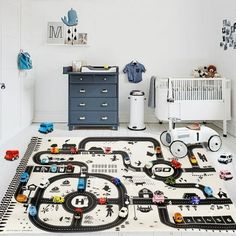 a child's playroom with cars and trucks on the rug