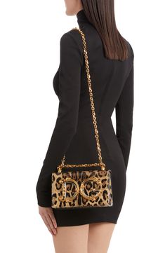 A baroque-inspired D&G logo adds to the glamour of this leopard-print leather bag featuring a pull-through strap that allows for crossbody or shoulder wear. Magnetic-snap flap closure Pull-through chain strap Leather lining Leather Made in Italy Designer Handbags Elegant Leopard Print Party Bag, Luxury Leopard Print Bags For Formal Events, Elegant Evening Shoulder Bag In Leopard Print, Designer Rectangular Bag In Leopard Print, Luxury Leopard Print Rectangular Bag, Designer Leather Bags In Leopard Print, Luxury Leopard Print Shoulder Bag With Gold-tone Hardware, Leopard Print Top Handle Evening Bag, Evening Leopard Print Bag With Detachable Strap