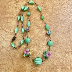 A stunning Art Deco Czech glass bead necklace.  This 1930s necklace features beautiful dainty glass flower beads in  green, yellow and pink. This necklace is in good condition and fastens with a barrel clasp.  Length of necklace: 20 inches.  ( 51 cm ) Please note all of my items are vintage so therefore pre owned and may have some wear.  To see more of my vintage necklaces please visit https://www.etsy.com/uk/shop/RippleRobins?section_id=39694898 1930s Necklace, Necklace Art Deco, Bead Choker Necklace, Necklace Art, Bead Choker, Vintage Necklaces, Deco Wedding, Art Deco Wedding, Flower Beads