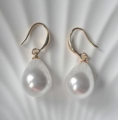 Add a touch of timeless elegance to your look with these exquisite large pearl earrings. Crafted from high-quality, hypoallergenic materials, these earrings are perfect for everyday wear or special occasions. **Key Features - **Material Copper with 14k gold plating - **Design Removable pearl droplets for versatile  - **Size Large artificial pearl  - **Closure thread **Why You'll Love Them - **Versatility Wear them for day to day or to dress up your outfit Perfect for gifting or treating yourself Elegant Hypoallergenic Pearl Earrings For Party, Elegant Hypoallergenic Teardrop Earrings For Parties, Elegant White Hypoallergenic Teardrop Earrings, Elegant Hypoallergenic Drop Earrings, Formal Pearl Teardrop Earrings, Elegant Hypoallergenic Drop Pearl Earrings, Formal White Hypoallergenic Teardrop Earrings, Elegant Hypoallergenic Teardrop Pearl Earrings, Elegant Pearl White Hypoallergenic Earrings