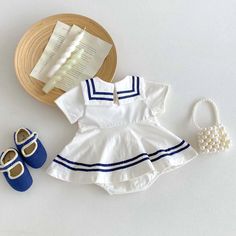 Set sail for cuteness overload with this adorable nautical baby dress! Featuring a classic navy blue sailor collar with white stripes, a darling bow accent, and breathable, lightweight fabric, this dress is perfect for summer adventures and seaside fun. 🌊☀️ Snaps at the back make dressing easy, and the charming nautical style is perfect for any occasion. Order now and let your little one's style set sail! ⛵️✨ Specifications: Gender: Girls Age Range: 6-24 months Pattern Type: Striped Material: C Spring Sailor-style Short Sleeve Dresses, Striped Summer Dress For Playtime, White Summer Dress For School, Playful Doll Collar Summer Dress, Sailor Style White Cotton Dress, White Sailor Cotton Dress, Playful Summer Dress With Doll Collar, White Cotton Sailor Dress, White Sailor Dresses For Spring