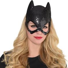 a woman wearing a cat mask with sequins on the face and long blonde hair