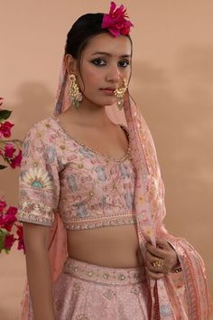 Pink lehenga with all over floral print and hand embroidered butti work. Paired with a blouse with floral print and embroidery work. Comes along with a dupatta. - Aza Fashions