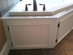 a bathroom sink with two faucets on top of it and tile flooring