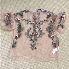 Never Been Worn Zara Sheer Shirt With Embroidery. Love The Shirt But Never Had A Chance To Wear It. The Embroidery Details Are Gorgeous. Material Is 100% Viscose. Has A Button In The Back (Comes With Back Up Button). Size Small. Elegant Crew Neck Top With Floral Embroidery, Feminine Embroidered V-neck Blouse, Elegant Floral Embroidered Crew Neck Top, Pink V-neck Top With Floral Embroidery, Festive Floral Embellished Summer Top, Spring Crew Neck Blouse With Floral Embroidery, Spring Short Sleeve Tops With Embroidery, Feminine Embroidered Short Sleeve Top, Spring Floral Embroidery Crew Neck Blouse