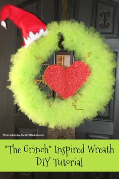 a green wreath with a red heart on it and the words, the grin inspired wreath di