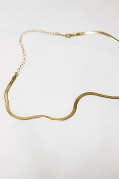 Lola Gold Herringbone Snake Chain Choker Necklace wraps perfectly around the neck and lobster claw closure. This item is currently sold out at the moment, it will take 1-2 weeks to make. Please pre-order now! Don't worry, we will keep you in the loop and message you when it is ready to ship! Thank you! ◊ 18K Gold Plated Over Brass ◊ Short length: 31 cm + 10 cm extension ◊ Long length: 38cm + 10 cm extension ◊ Chain measures 3mm wide ◊ The chain feels very lightweight and easy to wear ◊ Lobster c Adjustable Snake Chain Choker Necklace Gift, Adjustable Snake Chain Necklace As Gift, Gold Plated Snake Shaped Necklace With Adjustable Chain, Delicate Metal Snake-shape Chain Necklace, Gold Snake Chain Choker With Adjustable Chain, Gold Snake Chain Choker With Delicate Details, Gold Snake Shape Chain Necklace Gift, Gold Delicate Snake Chain Choker, Snake Shape Gold Chain Necklace Gift