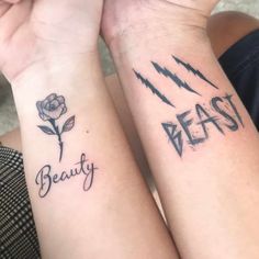 two people with matching tattoos on their arms that say beauty and beast, one has a rose