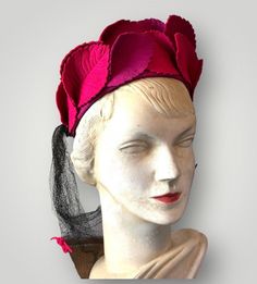 Here we have a fabulous 1940s  'statement' hat. The hat is American in origin no makers label, just a size label 22" The hat consists of beautifully crafted felt leaves in cerise and hot pink,  atop a cerise felt 'cap'. The hat is trimmed with a flowing net veil or mock snood that hangs down the back...this 'snood'  is decorated with little felt bows. Elastic to hold onto the hair. The hat is in good condition.... The 'snood' veil needs a steam. Size 22" Vintage Pink Fitted Headpieces, Vintage Fitted Pink Headpiece, Pink Vintage Fitted Headpiece, Fitted Vintage Pink Headpiece, Pink Headpiece For Kentucky Derby Vintage Events, Pink Felt Hat With Curved Brim For Party, Net Veil, Hat With Veil, Statement Hat