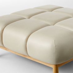 Designed by goop, the Sevigne leather ottoman invites low-slung lounging. Inspired by midcentury Italian modernism with a twist, our version is lifted entirely off the ground by American white oak legs certified sustainable by the Forest Stewardship Council r FSC for a lighter, fresher silhouette. Supple leather upholstery in a custom bone color and channel tufting softens the grid of ultra-plush cushioning. An unlacquered brass andamp;quot;gandamp;quot; medallion on the front leg for a refined Italian Modernism, Navy Velvet Chair, White Wood Furniture, Velvet Furniture, China Dinnerware Sets, Bone China Dinnerware, Brass Furniture, Chair Options, Leather Sectional Sofa