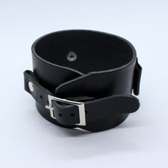 Johnny Depp style wide leather watchband adjustable by single buckle. This bracelet can be use as a wrist tattoo cover, besides it's suitable for most existing wristwatches. Before buy please measure your watch in 2 dimensions (see last picture in listing) and choose lug size you need. Between keepers we can add hole with diameter 20 or 26 mm for smart watch works right. To find other colors - check our items ( we will add new photos soon), on the photo - glossy black color. Suitable for standar Black Cuff Bracelet Watch Band, Black Cuff Bracelet Strap Watch Accessories, Black Leather Cuff Watch Bands, Black Leather Punk Wristband, Classic Black Bracelets With Wrist Strap, Classic Black Bracelet With Wrist Strap, Modern Black Leather Strap Wristband, Adjustable Black Watch Band With Wrist Strap, Black Cuff Watch Band For Gift