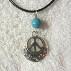 "Peace Sign Necklace -- Single Bead Minimalist Style A great fresh take on an old classic! This is a great looking necklace! Single 8mm Bead -- Choose your gemstone from the List All are Real Stone beads The overall length of the necklace is adjustable with a small chain, approximately 18.25\"-19.75\" range, and the necklace itself is made from 2mm black waxed nylon jewelry cord with crimped end connectors, jewelry hardware, findings, rings, and a lobster clasp closure -- made with the same stuf Casual Adjustable Necklace With Round Pendant, Casual Adjustable Round Pendant Necklace, Casual Handmade Round Necklace, Casual Adjustable Jewelry With Round Pendant, Symbolic Adjustable Beaded Necklace As Gift, Adjustable Round Choker For Festivals, Adjustable Round Charm Necklace Nickel Free, Adjustable Round Hippie Jewelry, Adjustable Nickel-free Round Charm Necklace